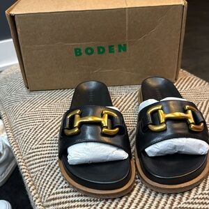 Boden black slide with gold horse bit buckle. Brand new with box.